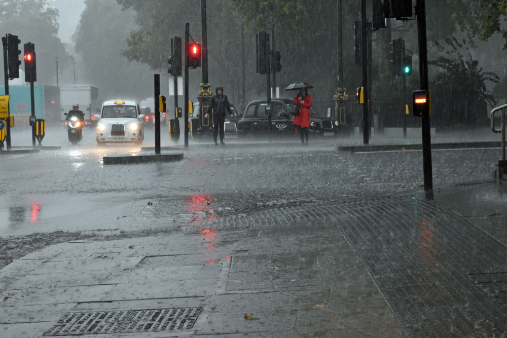 Flash flood in London people getting wet crossing the road